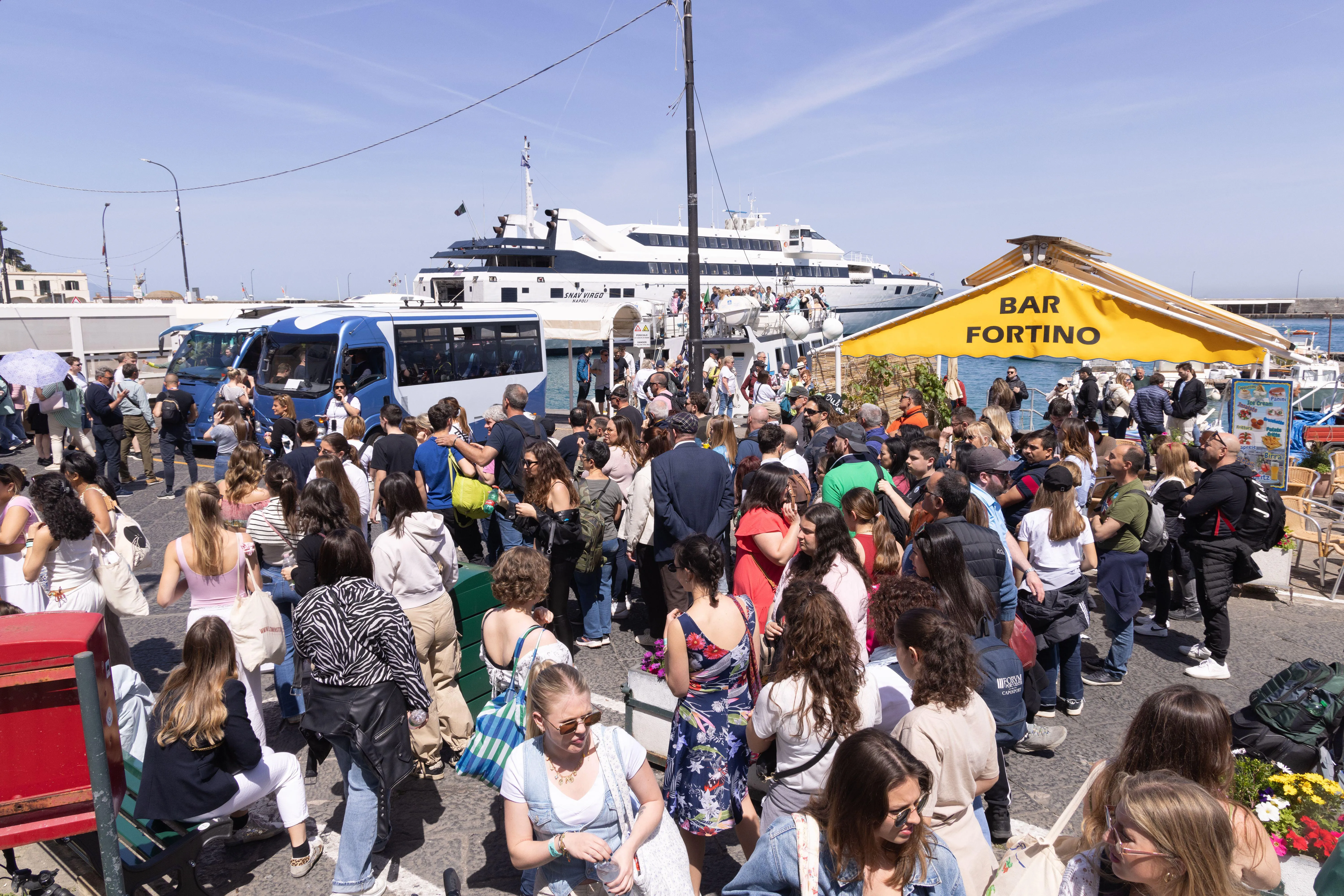Crowds of tourists at a coastal harbour showing the economic activity driven by marine tourism